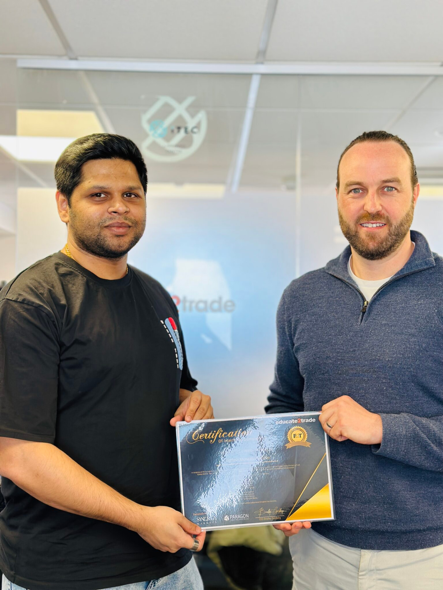 Vignesh receiving their Educate2Trade certificate