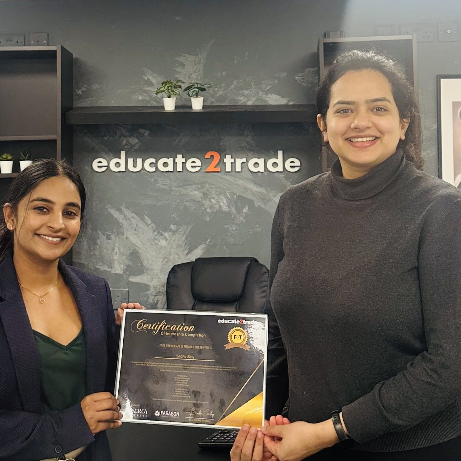 Sachu Siby receiving their Educate2Trade certificate