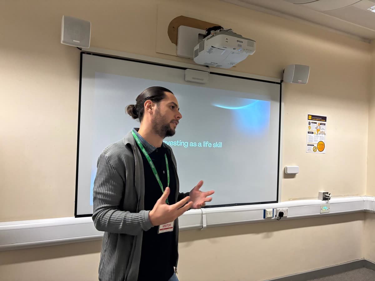 Educate2Trade mentor teaching investing as a life skill to Merton College students